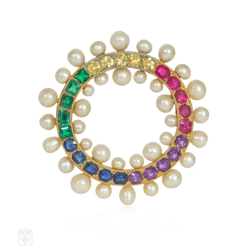 An Edwardian gem-set rainbow circle brooch