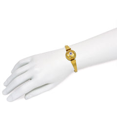 Antique gold bangle with central diamond and sapphire flower