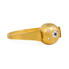 Antique gold bangle with central diamond and sapphire flower