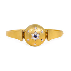 Antique gold bangle with central diamond and sapphire flower