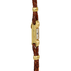 An Art Deco gold cocktail watch centered by a rectangular fa...