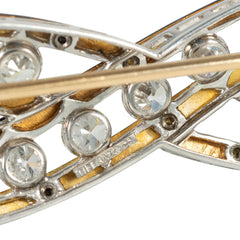 An Art Deco enamel and diamond infinity brooch
