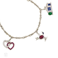 A diamond and gem-set charm bracelet