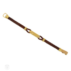 An Art Deco gold cocktail watch centered by a rectangular fa...