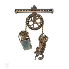 Antique diamond pulley brooch depicting a cat and a dog in a bucket
