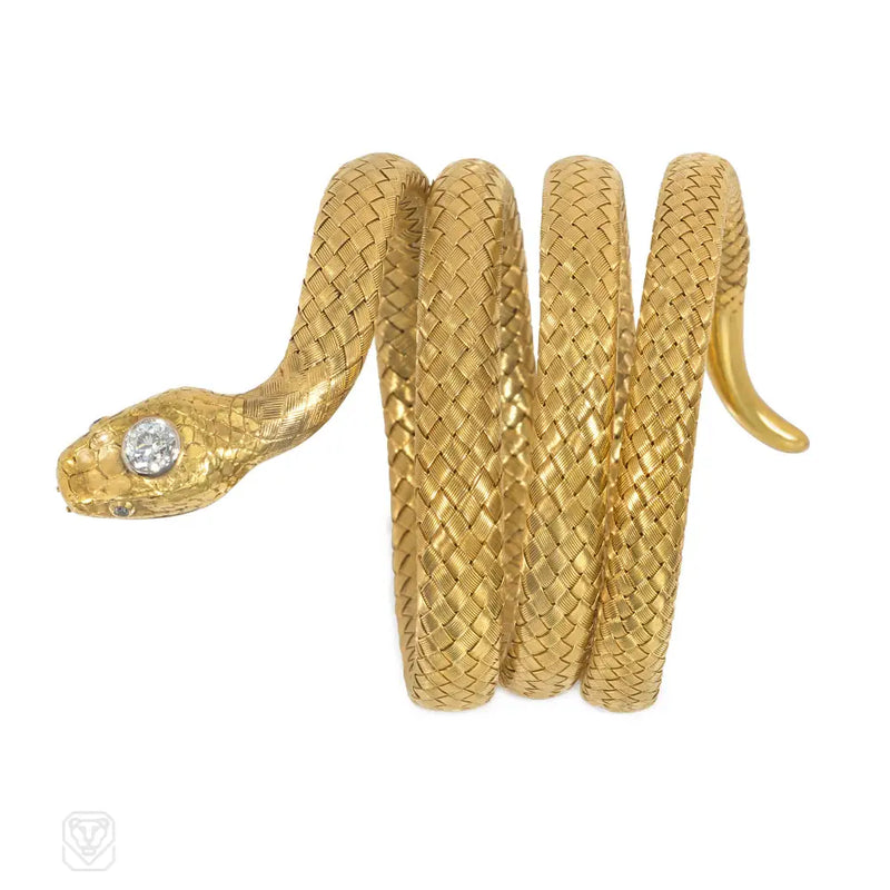 An Antique woven gold bangle in the form of a coiled serpent...