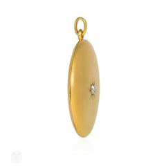 Antique round gold and diamond locket