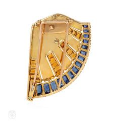 French Retro scroll brooch with sapphires and emerald