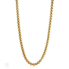 Gold bead necklace of adjustable length