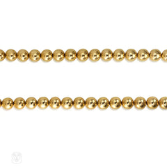 Gold bead necklace of adjustable length