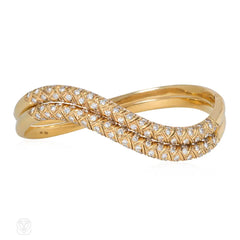 Pair of gold and diamond wave bracelets