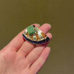 French Retro scroll brooch with sapphires and emerald